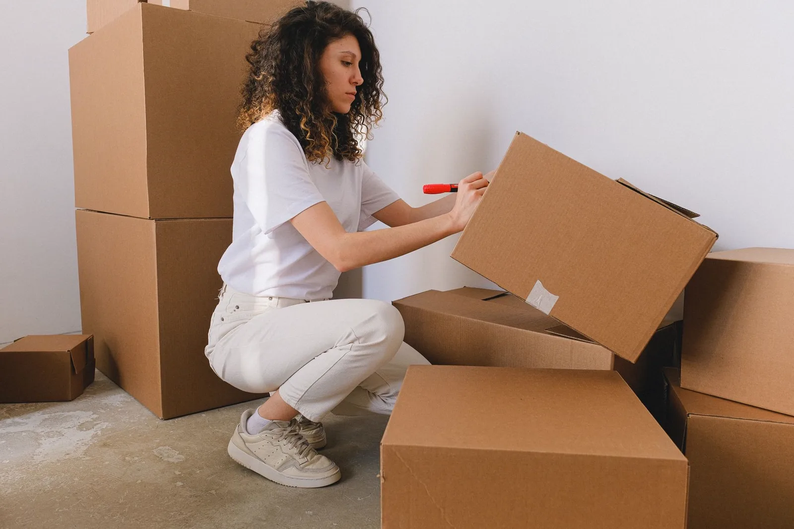 A person labeling cardboard boxes before dispatch