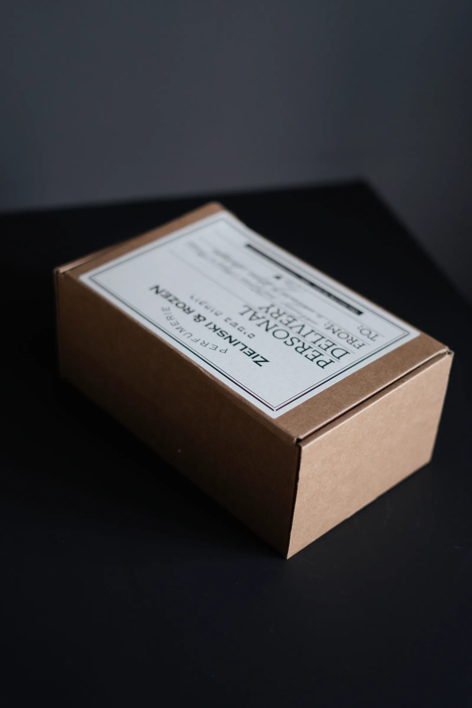 A labeled cardboard parcel representing low-value e-commerce imports