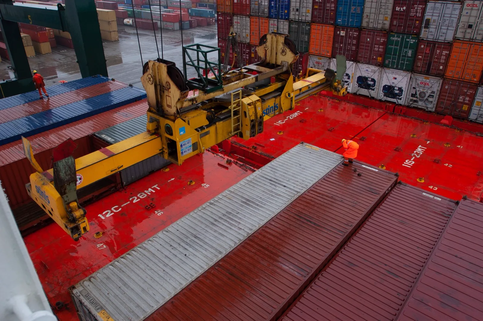 A container port crane moving freight between ship and terminal
