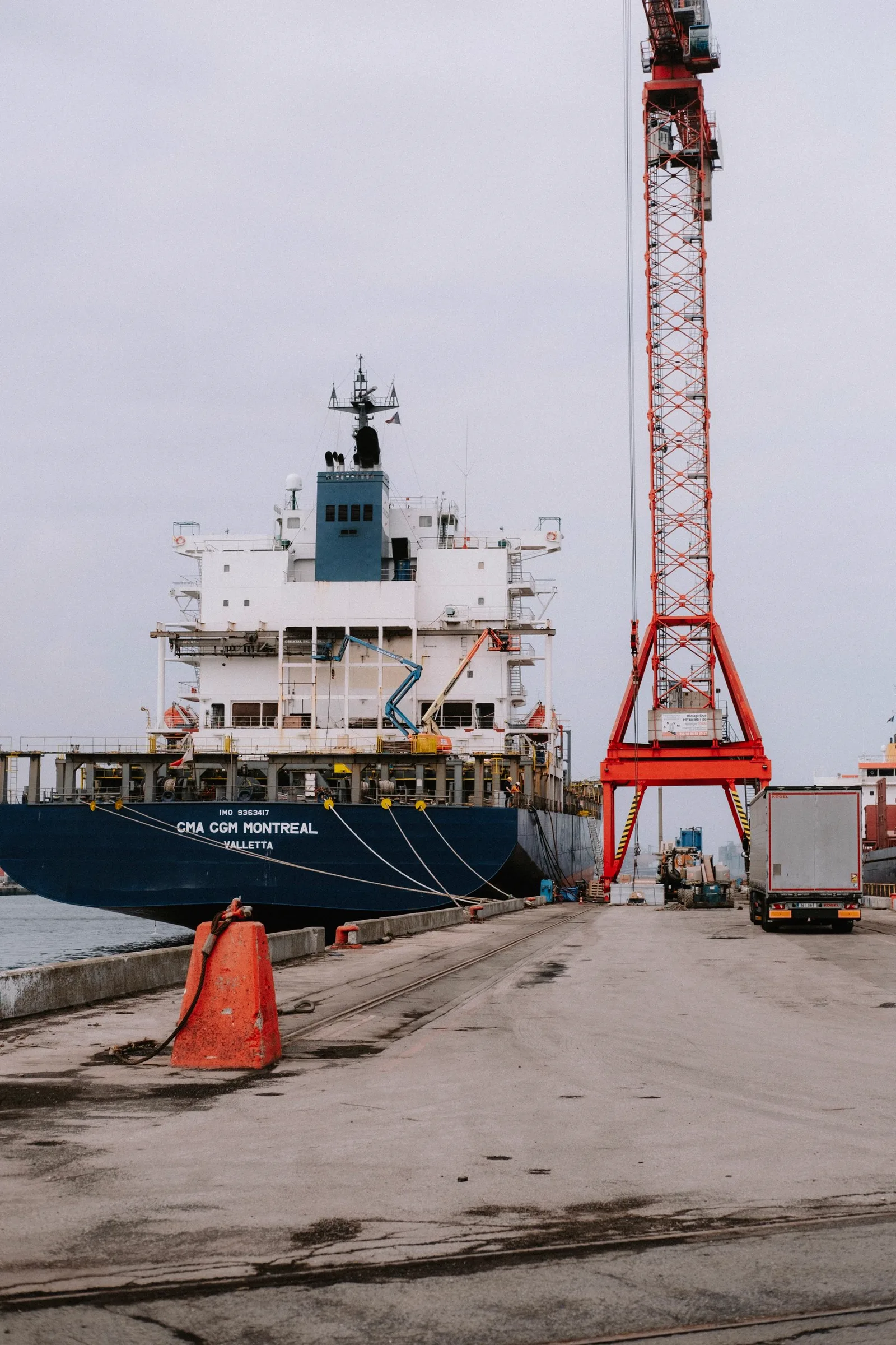 Container ship, cranes, and trucks operating at an international port