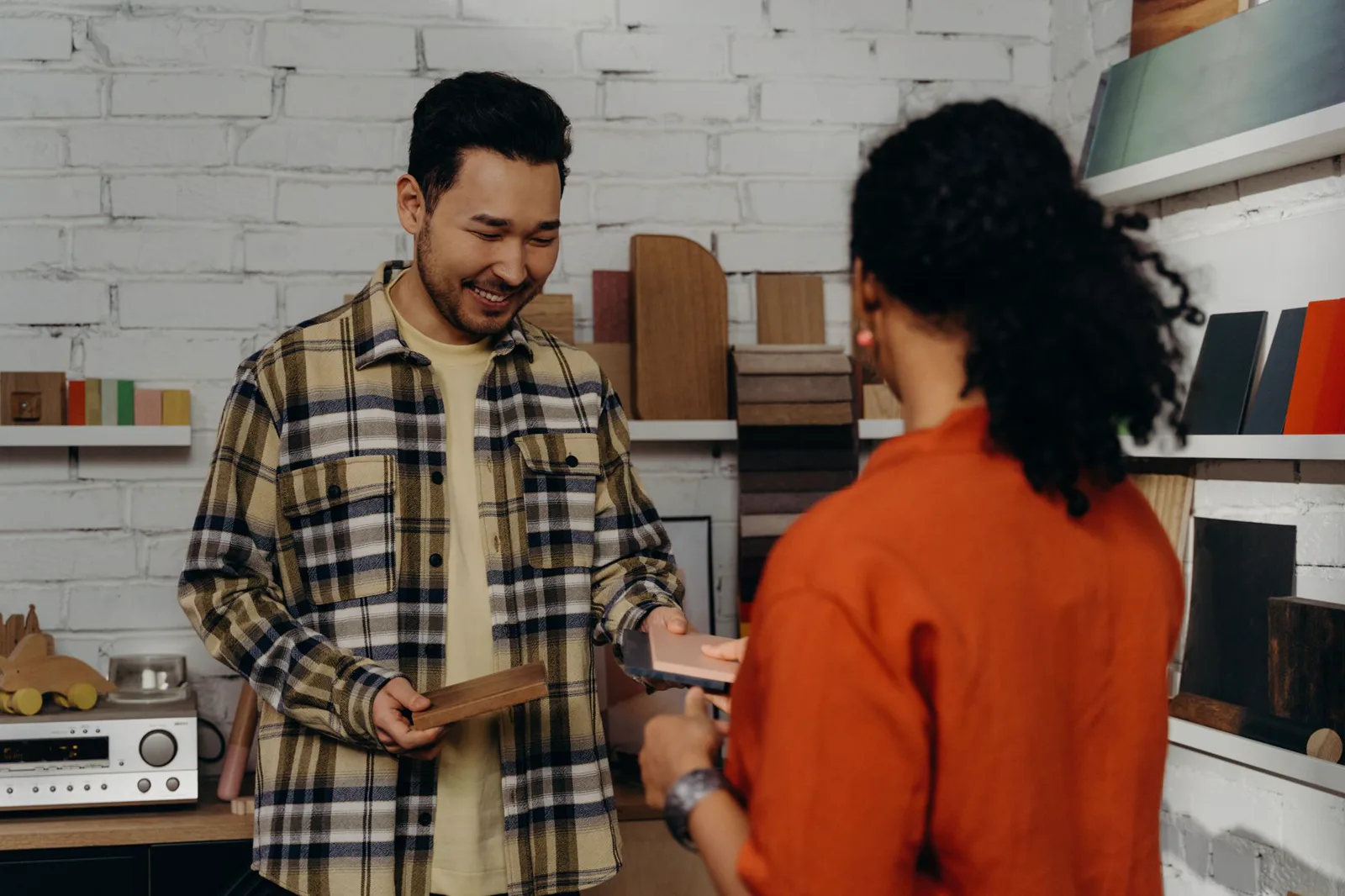 A specialist showing physical material samples to a buyer