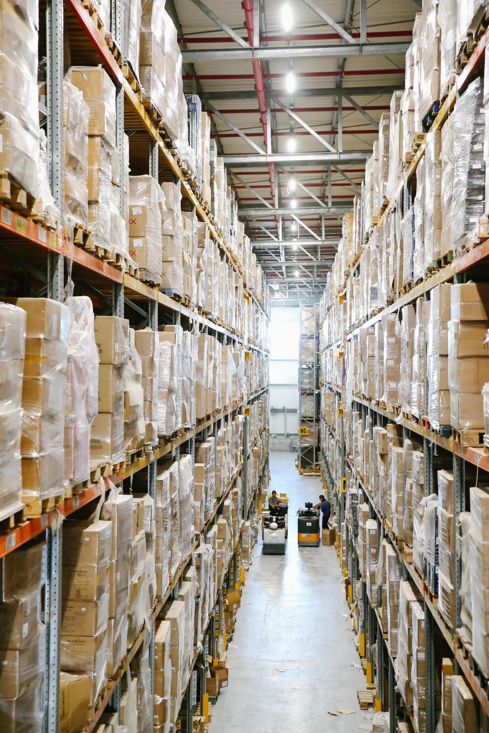 Warehouse aisles containing organized stock and packaging