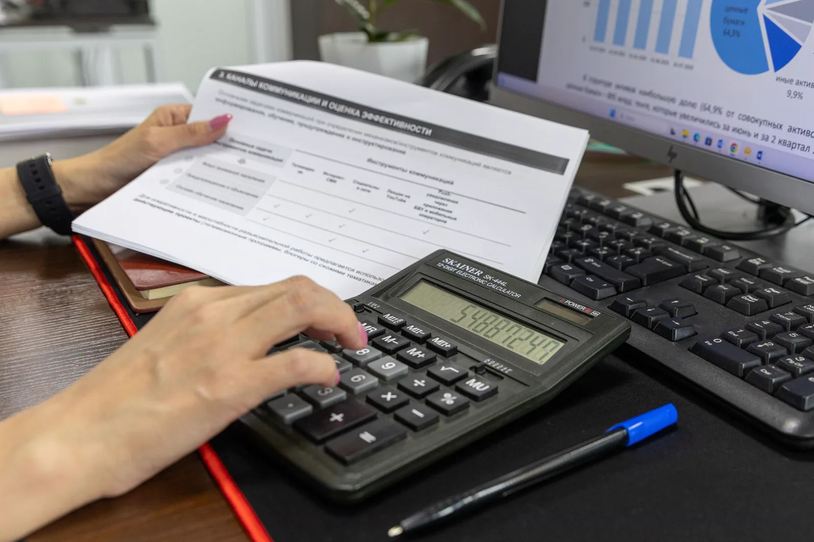 A buyer comparing figures in business documents with a calculator